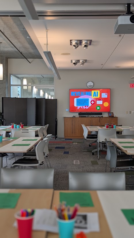 Library room with Revealing AI slides displayed onscreen